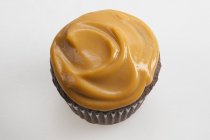 Cupcake topped with butterscotch pudding — Stock Photo