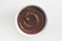 Chocolate pudding in white bowl — Stock Photo