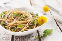 Wholemeal spaghetti pasta with dandelions — Stock Photo
