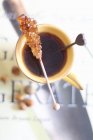 Candy stick on a cup of tea — Stock Photo