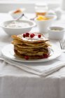 Stack of pancakes with redcurrants — Stock Photo