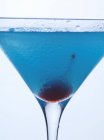 Blue Curaao cocktail with cocktail cherry — Stock Photo