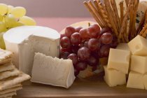 Cheese board with grapes — Stock Photo