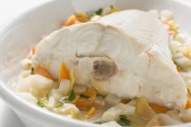 Stewed fish on root vegetables — Stock Photo