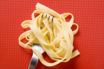 Tagliatelle pasta and fork — Stock Photo