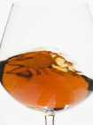Cognac swirling in a glass — Stock Photo