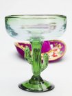 Closeup view of green cactus shaped cocktail glass with Mexican hat on white surface — Stock Photo
