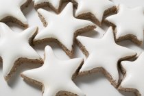 Cinnamon stars on white surface — Stock Photo