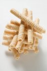 Closeup view of piled wafer rolls on white surface — Stock Photo