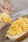 Child spreading scrambled egg — Stock Photo