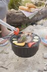 Cropped daytime view of person barbecuing vegetables and meat — Stock Photo