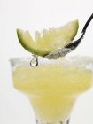 Frozen Margarita with lime wedge on spoon — Stock Photo