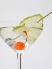 Drink with cocktail cherry and lime — Stock Photo