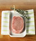 Raw loin of pork and bunch of thyme — Stock Photo