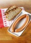 Frankfurters and two slices of bread — Stock Photo