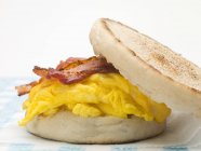English muffin filled with bacon — Stock Photo