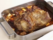 Roasted pork neck in roasting tin — Stock Photo