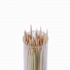 Closeup view of toothpicks in plastic container on white background — Stock Photo