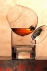 Vista ravvicinata del bicchiere di brandy su vetro d'acqua — Foto stock