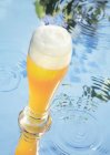 Wheat beer on water — Stock Photo