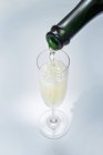 Pouring a glass of sparkling wine — Stock Photo