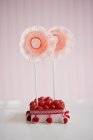 Red candies in box with sugared raspberries and lollies — Stock Photo