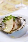 Oyster with slices of apple  on white plate — Stock Photo