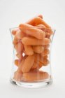 Baby carrots in glass — Stock Photo