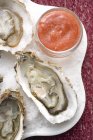 Fresh oysters with tomato sauce — Stock Photo