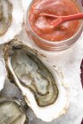 Fresh oysters with tomato sauce — Stock Photo