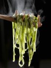 Cooked spinach tagliatelle pasta — Stock Photo