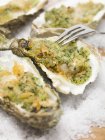 Oysters au gratin on ice — Stock Photo