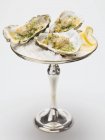 Oysters au gratin on silver stand — Stock Photo