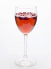 Closeup view of cranberry drink in glass on white background — Stock Photo