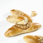 Whole and broken grain baguettes — Stock Photo