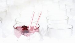 Closeup view of iced drink with blackberries and straws — Stock Photo