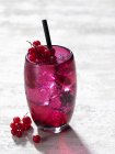 Cocktail with redcurrants in glass — Stock Photo