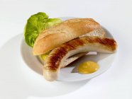 Grilled sausage in bread roll — Stock Photo