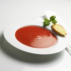 Tomato soup with toast and basil — Stock Photo