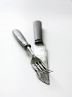 Closeup view of antique knife and fork on white surface — Stock Photo