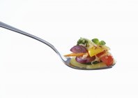 Vegetable gratin on fork on white background — Stock Photo