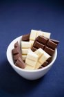 Chunks of white and dark chocolate — Stock Photo