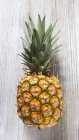 Pineapple on wooden slap — Stock Photo