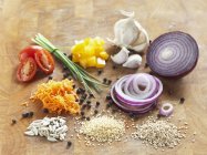 Assorted ingredients on a wooden board — Stock Photo