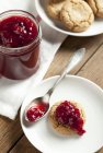 Redcurrant jam on biscuit and in jar — Stock Photo