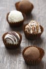 Chocolate truffles in cases — Stock Photo
