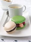 Macaroons with coffee in cup — Stock Photo