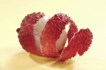Fresh partly peeled lychee — Stock Photo
