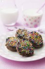 Chocolate pikelets with sugar sprinkles — Stock Photo
