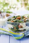 Closeup view of spinach and pumpkin salad in glass bowl — Stock Photo